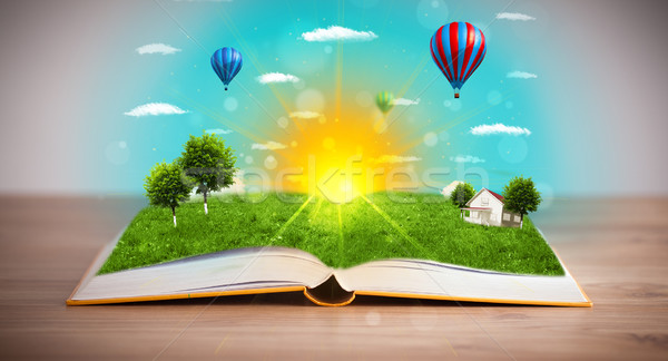 Open book with green nature world coming out of its pages Stock photo © ra2studio