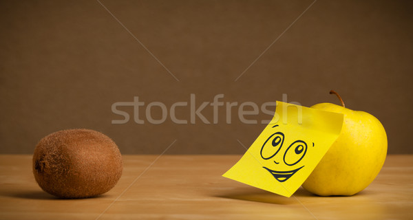 Apple with post-it note looking at kiwi Stock photo © ra2studio