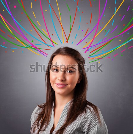 Young girl thinking with colorful abstract lines overhead Stock photo © ra2studio