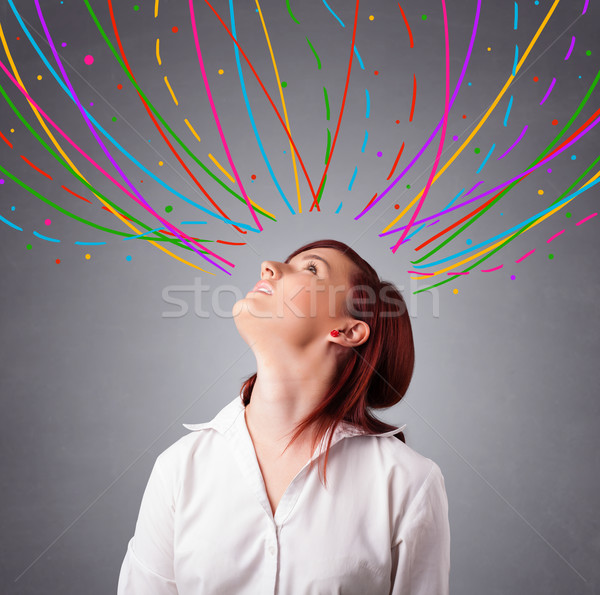 Young girl thinking with colorful abstract lines overhead Stock photo © ra2studio