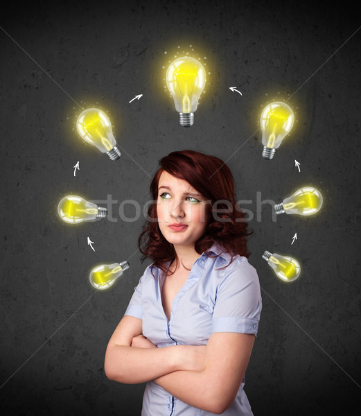 Young woman thinking with lightbulb circulation around her head Stock photo © ra2studio