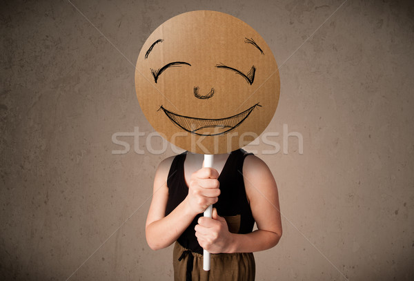 Fiatal nő tart mosolygós arc tábla fiatal hölgy Stock fotó © ra2studio