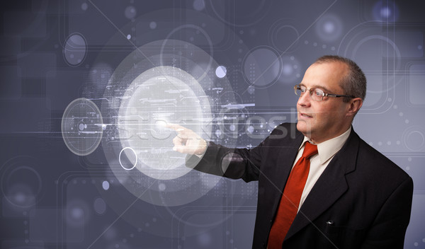 Stock photo: Businessman touching abstract high technology circular buttons