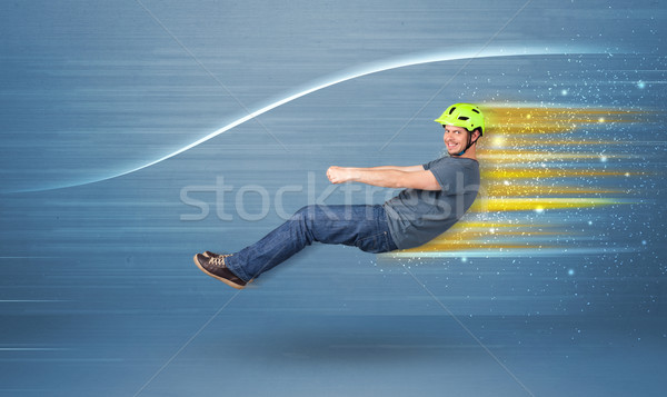 Young man driving in imaginary fast car with blurred lines  Stock photo © ra2studio