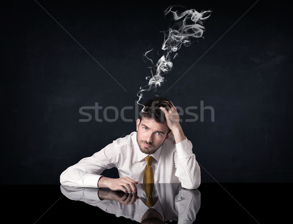 Stock photo: Depressed businessman with smoking head