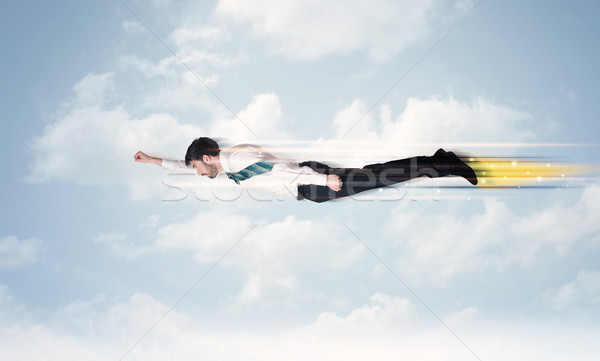 Heureux homme d'affaires battant rapide ciel nuages Photo stock © ra2studio
