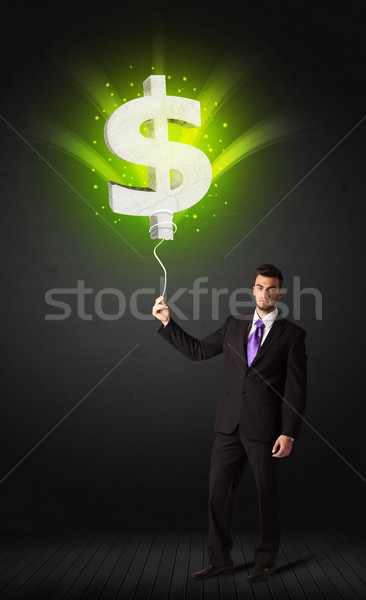 Geschäftsmann Dollarzeichen Ballon halten grünen Stock foto © ra2studio
