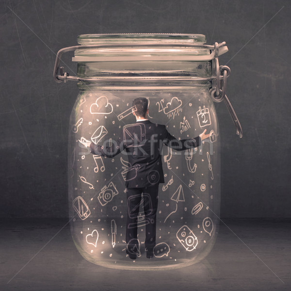 Stock photo: Business man captured in glass jar with hand drawn media icons c