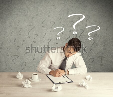 Businessman at desk with question mark Stock photo © ra2studio