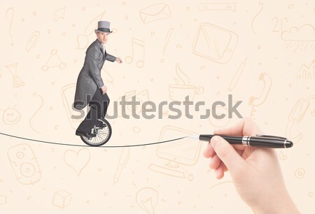 Businessman riding monocycle on a rope drawn by hand Stock photo © ra2studio