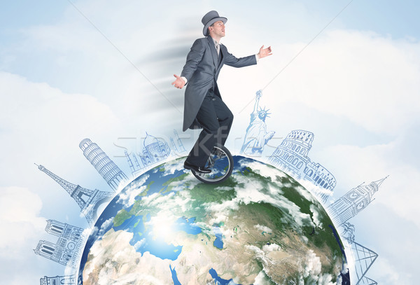Man riding unicycle around the globe with major cities Stock photo © ra2studio