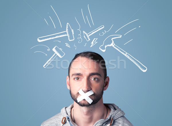 Young man with glued mouth and beating hammer marks Stock photo © ra2studio