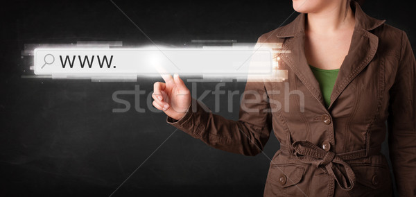 Young businesswoman touching web browser address bar with www si Stock photo © ra2studio