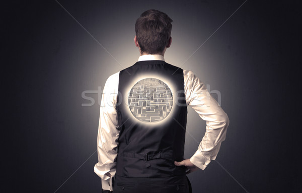Businessman standing with maze on his back Stock photo © ra2studio