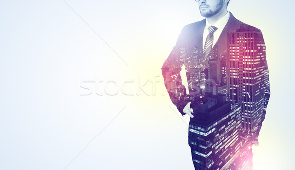 Businessman standing with night city graphic Stock photo © ra2studio
