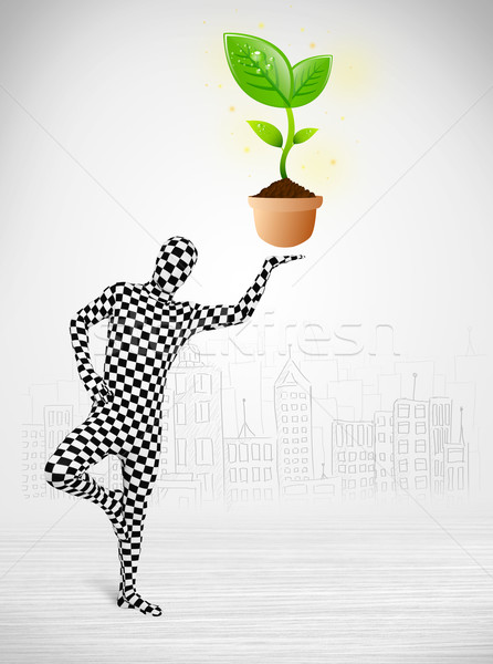 Stock photo: man in full body suit with eco plant