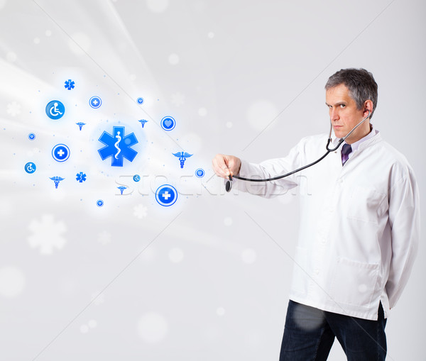 Doctor with blue medical icons Stock photo © ra2studio