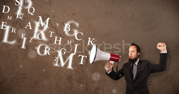 Stock photo: Man in shirt shouting into megaphone and text come out