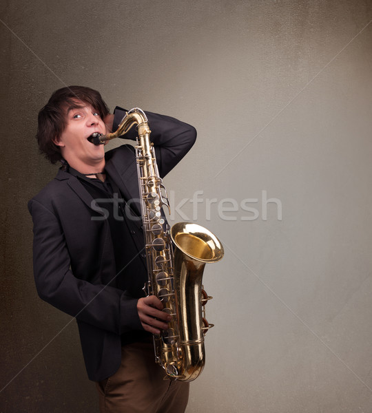 Young musician playing on saxophone Stock photo © ra2studio