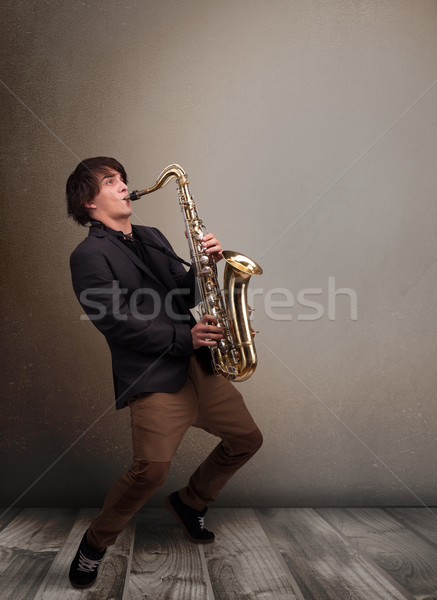 Young musician playing on saxophone Stock photo © ra2studio