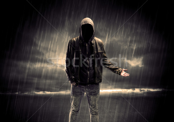 Stock photo: Anonymous terrorist in hoodie at night