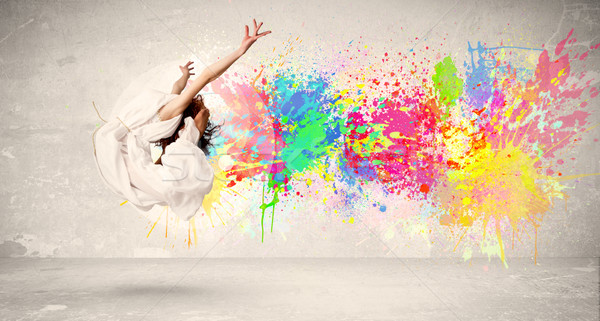 Felice adolescente jumping colorato inchiostro splatter Foto d'archivio © ra2studio