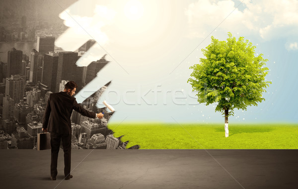 Salesman painting tree instead of city Stock photo © ra2studio
