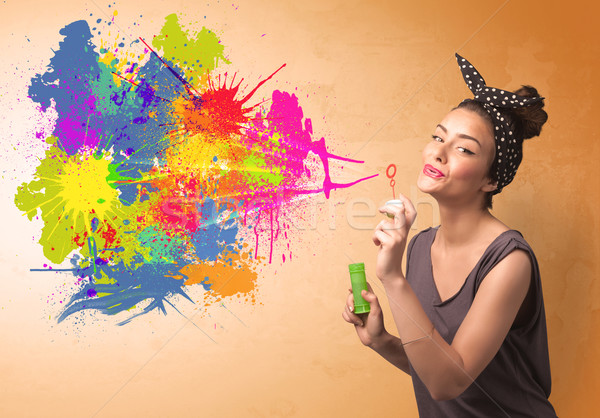 Cute girl blowing colorful splash graffiti  Stock photo © ra2studio
