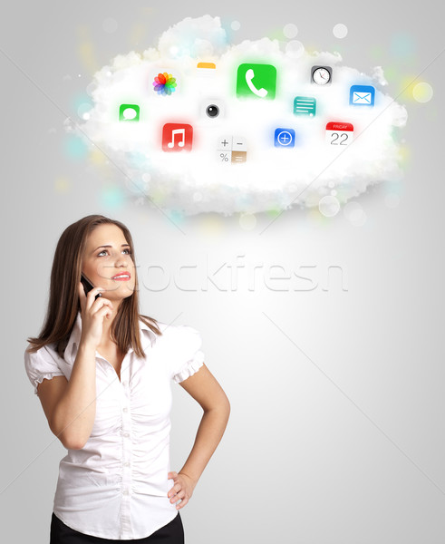 Young woman presenting cloud with colorful app icons and symbols Stock photo © ra2studio