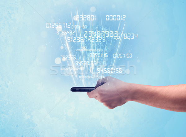 Hand holding phone with digital numbers Stock photo © ra2studio