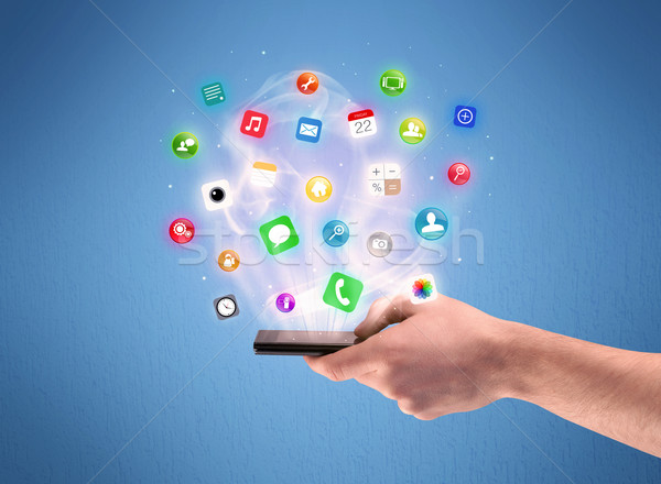 Hand holding tablet phone with app icons Stock photo © ra2studio