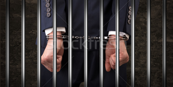 Close handcuffed man in jail Stock photo © ra2studio