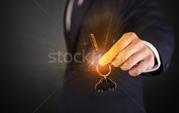 Man in suit hand over keys Stock photo © ra2studio