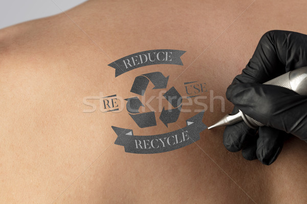 Tattooing recycle for a better environment concept on naked back Stock photo © ra2studio