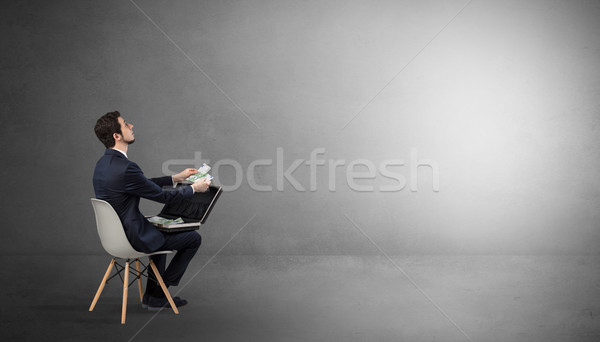Businessman staying in an empty room with stuffs on his lap Stock photo © ra2studio