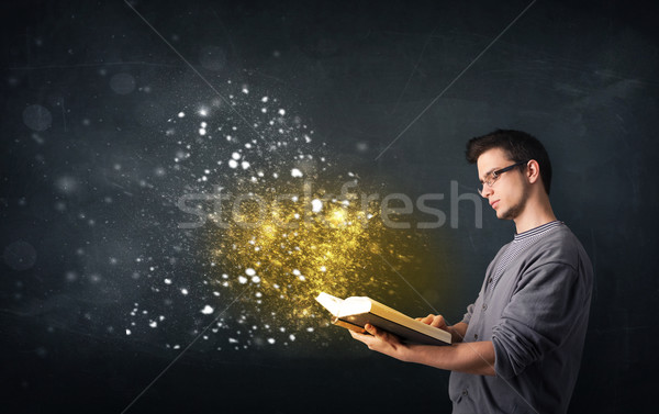 Young guy reading a magical book Stock photo © ra2studio