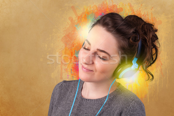 Young woman with headphones listening to music Stock photo © ra2studio