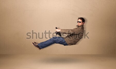 Happy funny man driving a flying car concept Stock photo © ra2studio
