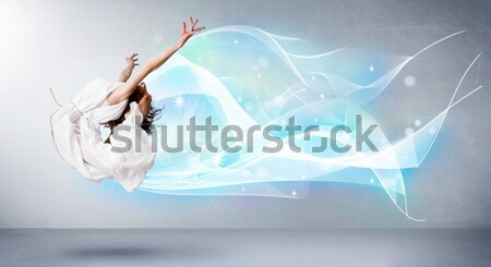 Beautiful woman jumping with colorful gems and crystals on the b Stock photo © ra2studio