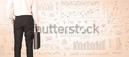 Stock photo: Businessman with diagrams and graphs