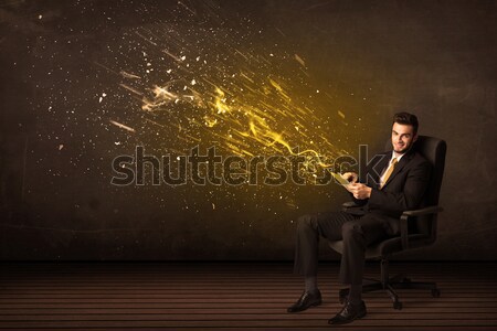 Businessman with tablet and energy explosion on background Stock photo © ra2studio