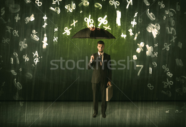 Businessman standing with umbrella and 3d numbers raining concep Stock photo © ra2studio