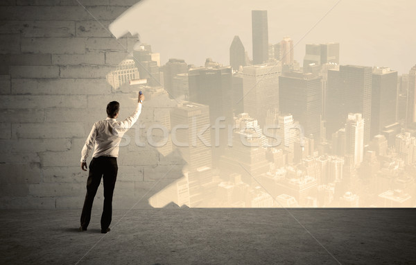 Salesman painting city scape on wall Stock photo © ra2studio