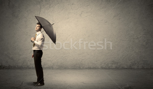 Handsome business man holding umbrella with copy space backgroun Stock photo © ra2studio