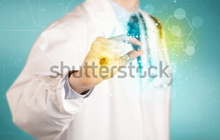 A doctor in tie holding a pill Stock photo © ra2studio