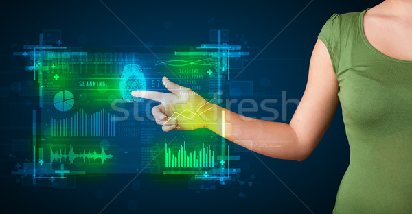 Young businesswoman pressing modern technology panel with finger Stock photo © ra2studio