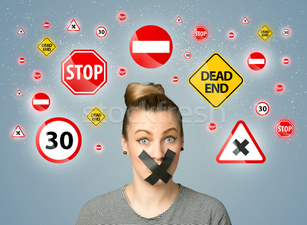 Young woman with glued mouth and traffic signals Stock photo © ra2studio