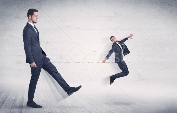 Big man kicking small man with grungy background Stock photo © ra2studio