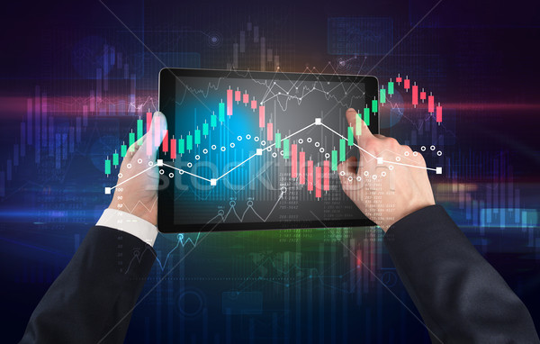 Stock photo: Hand holding tablet with global reports and stock market change concept