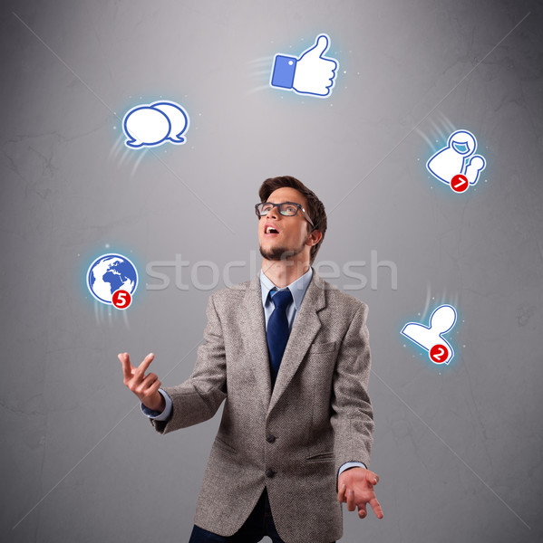 handsome young boy juggling with social media icons Stock photo © ra2studio